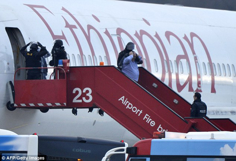 Police evacuate passengers from the Ethiopian Airlines flight