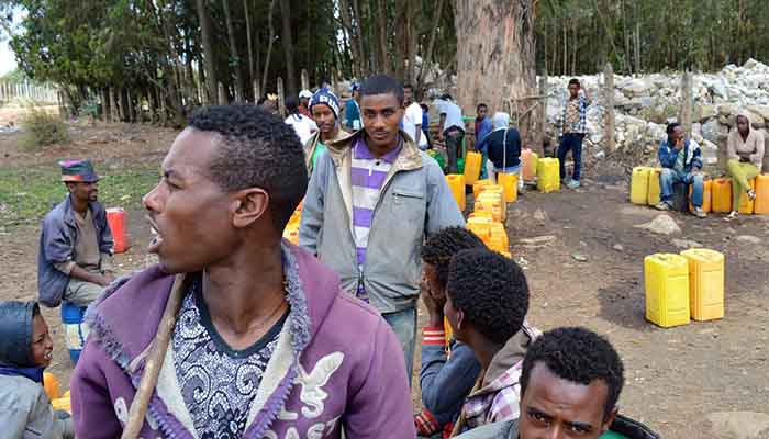 People in Sululta queue for tap water.